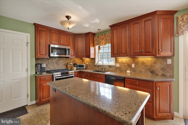 32 Duffield Dr, Lititz, PA 17543 - kitchen with appliances with stainless steel finishes, light stone countertops, decorative backsplash, a kitchen island, and brown cabinetry
