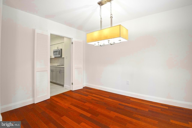 7809 Heatherton Ln, Potomac, MD 20854 - unfurnished dining area with baseboards and hardwood / wood-style floors