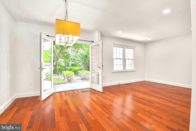 7809 Heatherton Ln, Potomac, MD 20854 - unfurnished dining area with wood finished floors, a chandelier, and recessed lighting