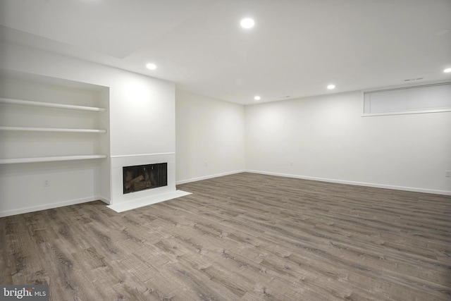 7809 Heatherton Ln, Potomac, MD 20854 - unfurnished living room with recessed lighting, wood finished floors, a fireplace, and built in features