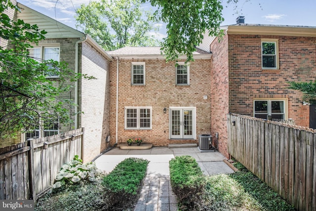 7809 Heatherton Ln, Potomac, MD 20854 - back of property featuring a patio area, brick siding, a fenced backyard, and french doors