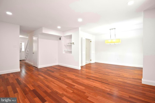 7809 Heatherton Ln, Potomac, MD 20854 - empty room with wood finished floors, recessed lighting, and stairs
