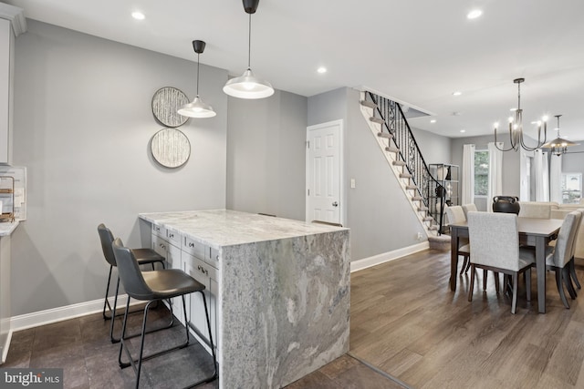 7357 E Walnut Ln, Philadelphia, PA 19138 - kitchen with a chandelier, recessed lighting, light stone countertops, white cabinets, and dark wood-style floors