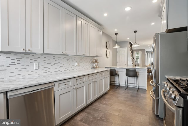 7357 E Walnut Ln, Philadelphia, PA 19138 - kitchen with stainless steel appliances, tasteful backsplash, recessed lighting, pendant lighting, and light stone countertops