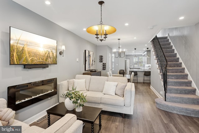 7357 E Walnut Ln, Philadelphia, PA 19138 - living area with stairs, wood finished floors, recessed lighting, and a chandelier