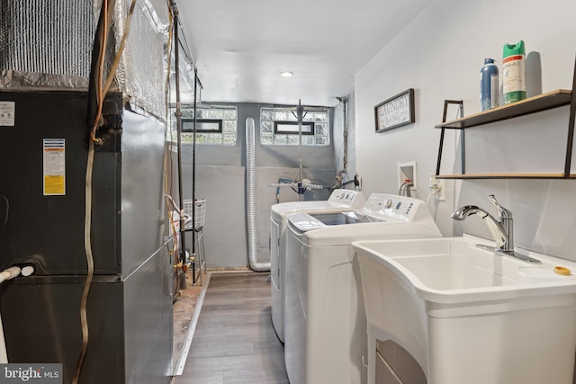 7357 E Walnut Ln, Philadelphia, PA 19138 - laundry room featuring independent washer and dryer, wood finished floors, heating unit, and recessed lighting