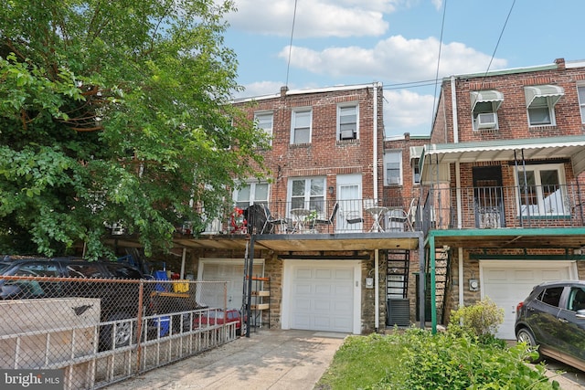 7357 E Walnut Ln, Philadelphia, PA 19138 - multi unit property featuring a garage, brick siding, and concrete driveway