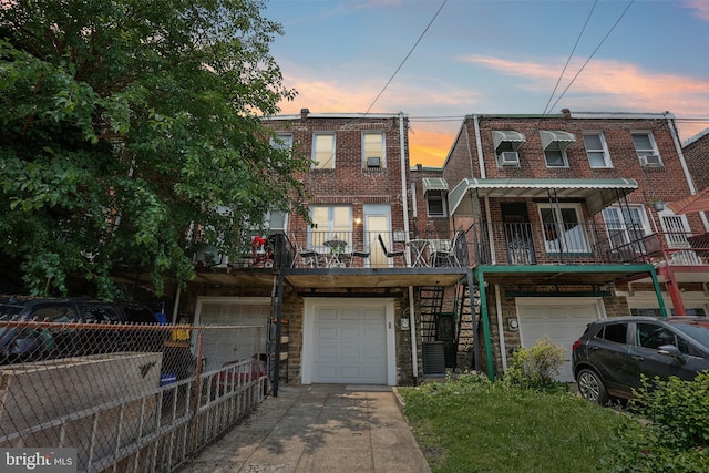 7357 E Walnut Ln, Philadelphia, PA 19138 - multi unit property with an attached garage, concrete driveway, stone siding, and stairway