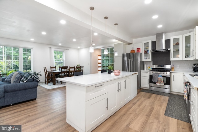 3789 Spring Rd, Carlisle, PA 17013 - kitchen featuring appliances with stainless steel finishes, wall chimney exhaust hood, light wood-type flooring, decorative backsplash, and recessed lighting
