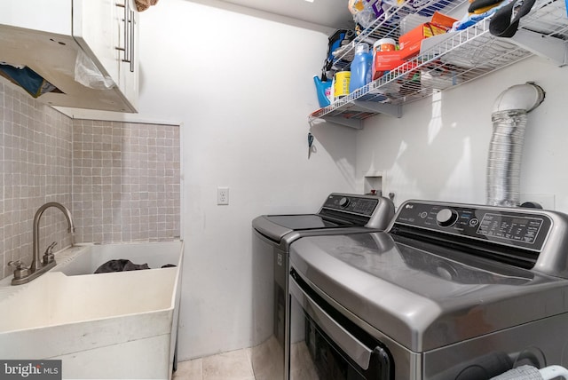 3789 Spring Rd, Carlisle, PA 17013 - washroom featuring washing machine and clothes dryer, cabinet space, and light tile patterned floors