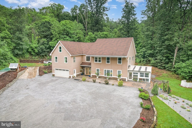 3789 Spring Rd, Carlisle, PA 17013 - colonial-style house with driveway, an attached garage, a view of trees, and a porch