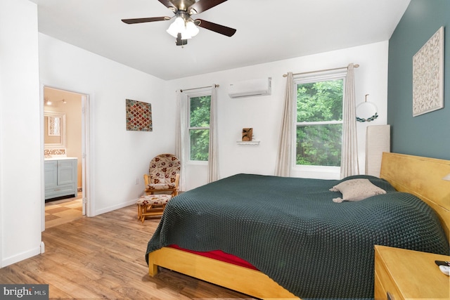 3789 Spring Rd, Carlisle, PA 17013 - bedroom featuring a wall mounted AC, light wood-type flooring, connected bathroom, and a ceiling fan
