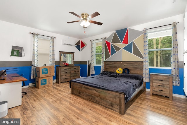 3789 Spring Rd, Carlisle, PA 17013 - bedroom featuring wood finished floors, a wall unit AC, and a ceiling fan