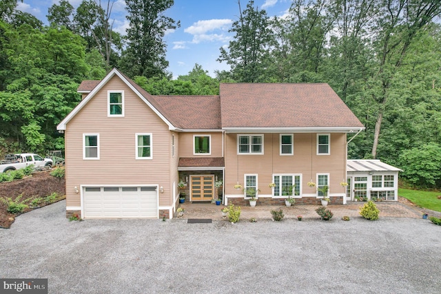 3789 Spring Rd, Carlisle, PA 17013 - view of front of home featuring gravel driveway, a garage, roof with shingles, and view of scattered trees
