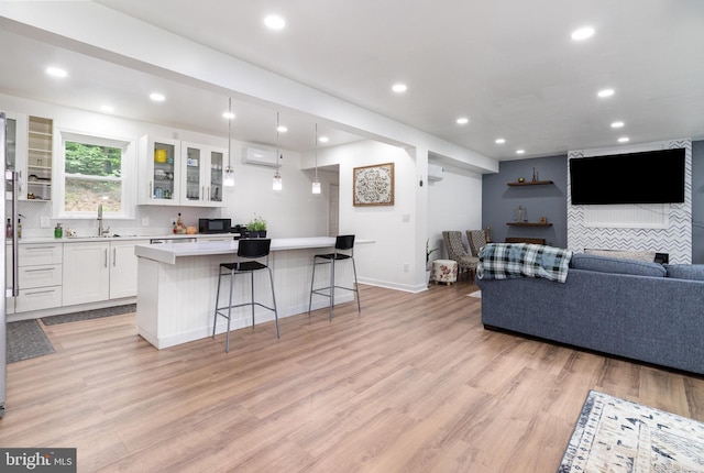 3789 Spring Rd, Carlisle, PA 17013 - living room featuring a wall mounted AC, light wood finished floors, and recessed lighting