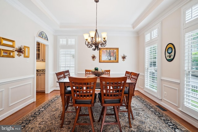114 Lake St, Gaithersburg, MD 20878 - dining space with light wood-type flooring, a chandelier, a wainscoted wall, ornamental molding, and a tray ceiling