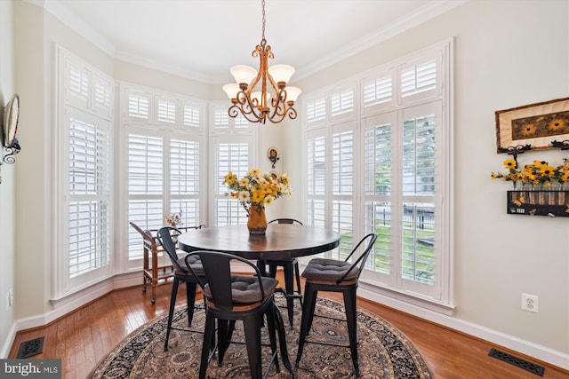 114 Lake St, Gaithersburg, MD 20878 - dining space featuring healthy amount of natural light, a chandelier, crown molding, and wood finished floors