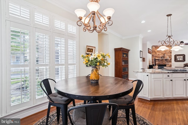 114 Lake St, Gaithersburg, MD 20878 - dining room with a chandelier, crown molding, light wood finished floors, a fireplace, and recessed lighting