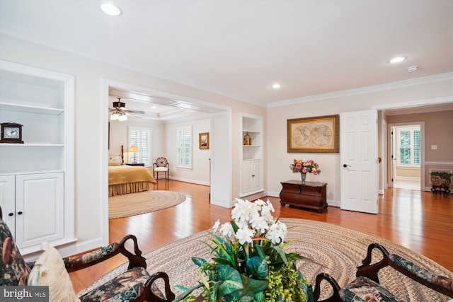 114 Lake St, Gaithersburg, MD 20878 - living room with wood finished floors, built in shelves, crown molding, healthy amount of natural light, and ceiling fan