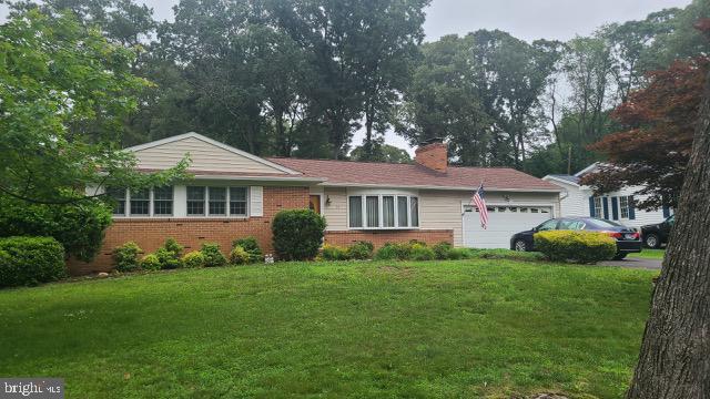 16 Gray Dr, Pasadena, MD 21122 - ranch-style home with an attached garage, a front lawn, brick siding, and a chimney