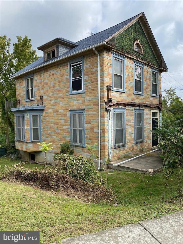4616 Foote St NE, Washington, DC 20019 - view of side of home with stone siding, a patio area, and a lawn