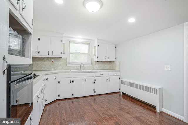 328 Spruce St, Bridgeton, NJ 08302 - kitchen featuring radiator, oven, decorative backsplash, white cabinetry, and light countertops