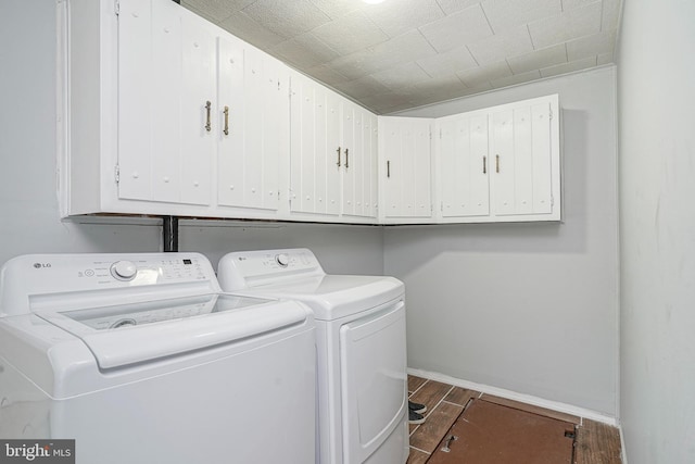 328 Spruce St, Bridgeton, NJ 08302 - laundry room featuring washer and dryer, dark wood-style flooring, and cabinet space