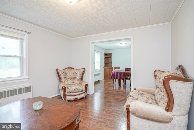328 Spruce St, Bridgeton, NJ 08302 - sitting room featuring radiator heating unit, wood finished floors, and ornamental molding