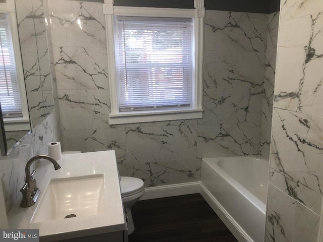 308 E 23rd St, Wilmington, DE 19802 - full bathroom with a tub, vanity, healthy amount of natural light, and wood finished floors