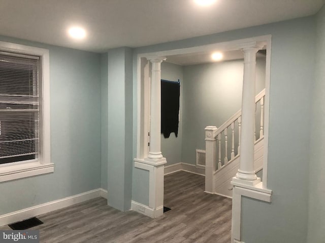 308 E 23rd St, Wilmington, DE 19802 - empty room with wood finished floors, stairway, and decorative columns
