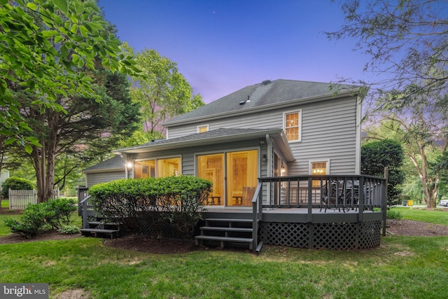 1092 Carriage Hill Pkwy, Annapolis, MD 21401 - back of house at dusk featuring a lawn and a wooden deck