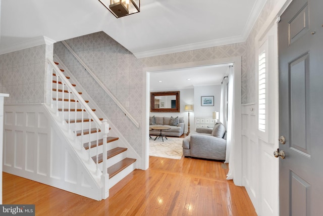 1092 Carriage Hill Pkwy, Annapolis, MD 21401 - entrance foyer featuring wallpapered walls, ornamental molding, light wood-type flooring, and stairway