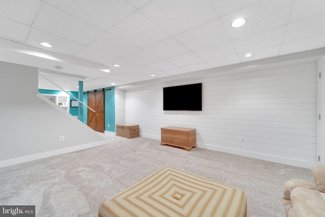 1092 Carriage Hill Pkwy, Annapolis, MD 21401 - unfurnished living room featuring carpet flooring, recessed lighting, a drop ceiling, wooden walls, and a barn door