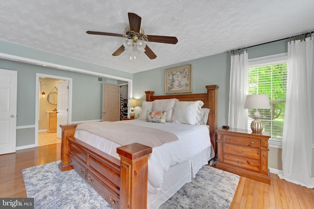 1092 Carriage Hill Pkwy, Annapolis, MD 21401 - bedroom featuring light wood finished floors, a ceiling fan, and connected bathroom