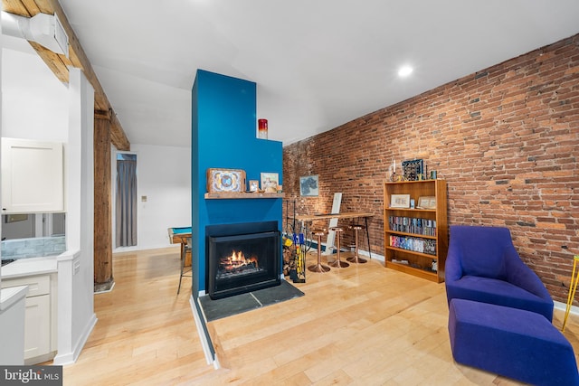 114 Naudain St Unit A, Philadelphia, PA 19147 - sitting room featuring light wood finished floors, brick wall, and a fireplace with flush hearth