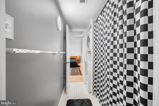 114 Naudain St Unit A, Philadelphia, PA 19147 - corridor featuring stacked washing machine and dryer and tile patterned floors