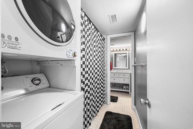 114 Naudain St Unit A, Philadelphia, PA 19147 - laundry room featuring stacked washer / dryer and tile patterned floors