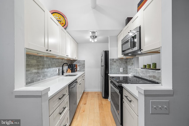 114 Naudain St Unit A, Philadelphia, PA 19147 - kitchen with appliances with stainless steel finishes, light countertops, and tasteful backsplash