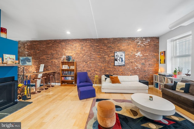 114 Naudain St Unit A, Philadelphia, PA 19147 - living area featuring wood finished floors, a fireplace, brick wall, and recessed lighting