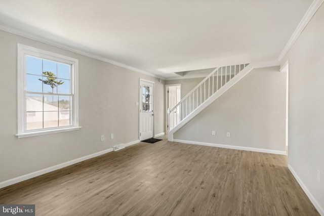 549 Madison Ave, Warminster, PA 18974 - unfurnished living room featuring ornamental molding, stairway, and wood finished floors