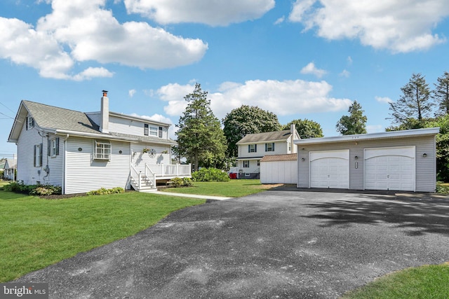 549 Madison Ave, Warminster, PA 18974 - view of front of property with an outbuilding, a chimney, a front lawn, and a detached garage