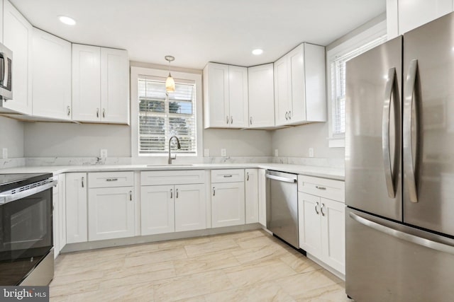 549 Madison Ave, Warminster, PA 18974 - kitchen featuring appliances with stainless steel finishes, light countertops, white cabinetry, light marble finish floors, and recessed lighting
