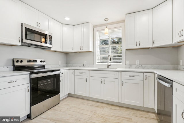 549 Madison Ave, Warminster, PA 18974 - kitchen with appliances with stainless steel finishes, white cabinetry, recessed lighting, and pendant lighting