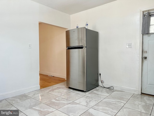 515 Dorsey, Essex, MD 21221 - kitchen featuring freestanding refrigerator and baseboards