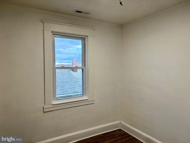 515 Dorsey, Essex, MD 21221 - spare room with dark wood-type flooring and crown molding
