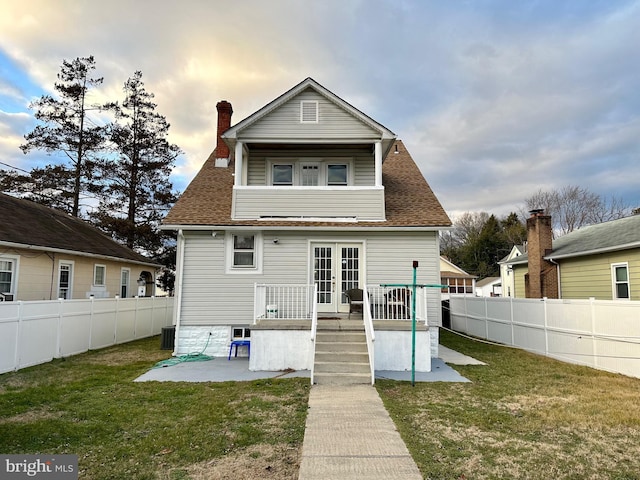 515 Dorsey, Essex, MD 21221 - rear view of house with french doors, a fenced backyard, a wooden deck, and a shingled roof