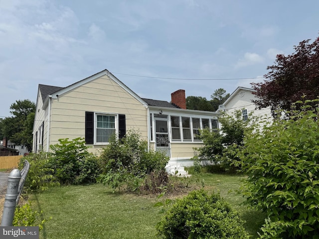 1027 E Washington St, Strasburg, VA 22657 - rear view of house featuring a chimney and a sunroom