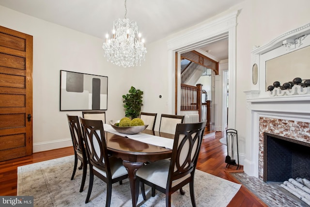 1240 Girard St NW, Washington, DC 20009 - dining area featuring a chandelier, wood finished floors, stairway, and a tile fireplace
