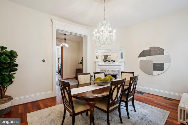 1240 Girard St NW, Washington, DC 20009 - dining space featuring a chandelier, wood finished floors, and a fireplace