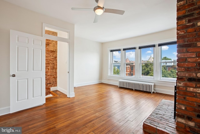 1240 Girard St NW, Washington, DC 20009 - unfurnished room with radiator, ceiling fan, plenty of natural light, and wood-type flooring